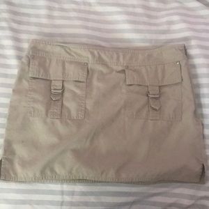 Tan mini skirt with two pockets in front w/ zipper
